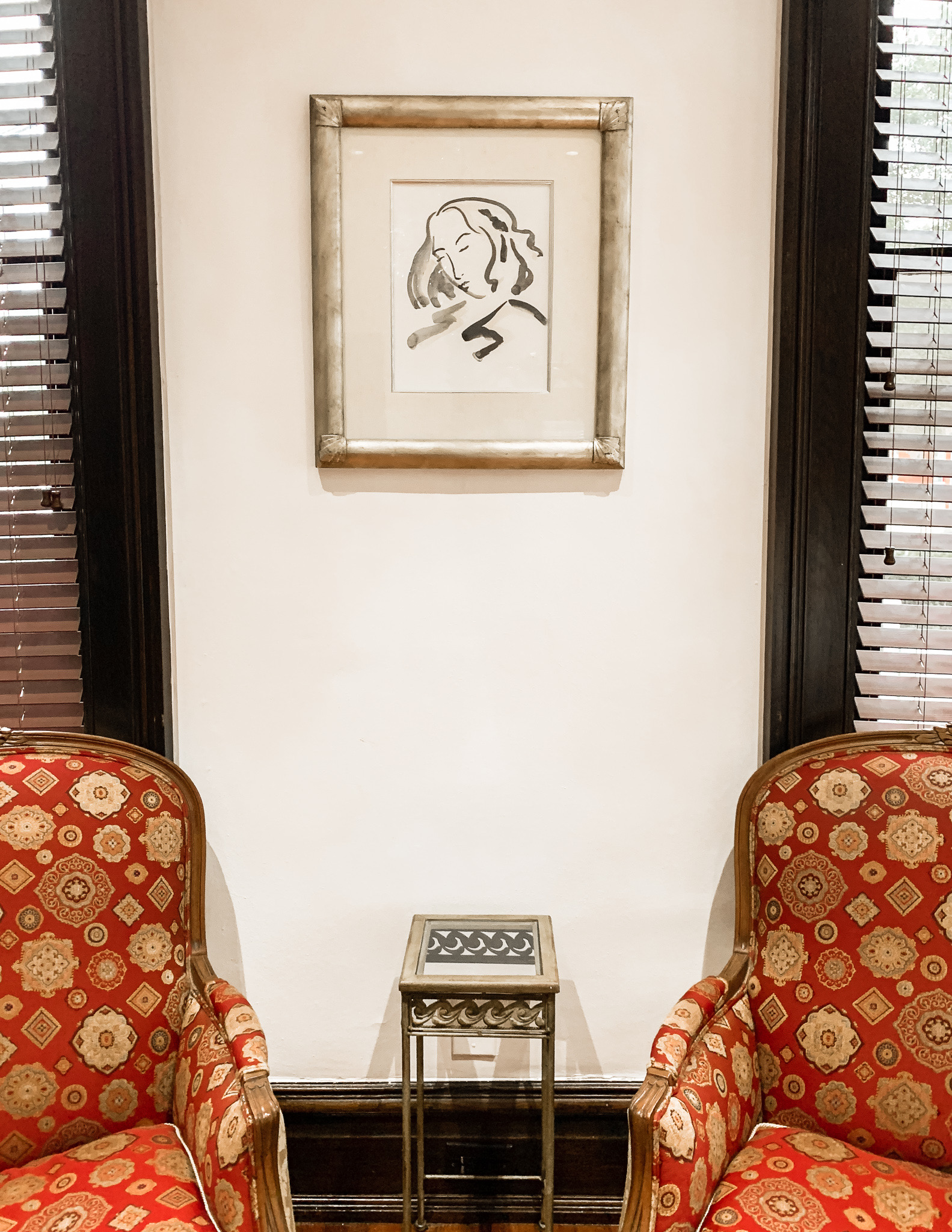 Wall art and two patterned chairs