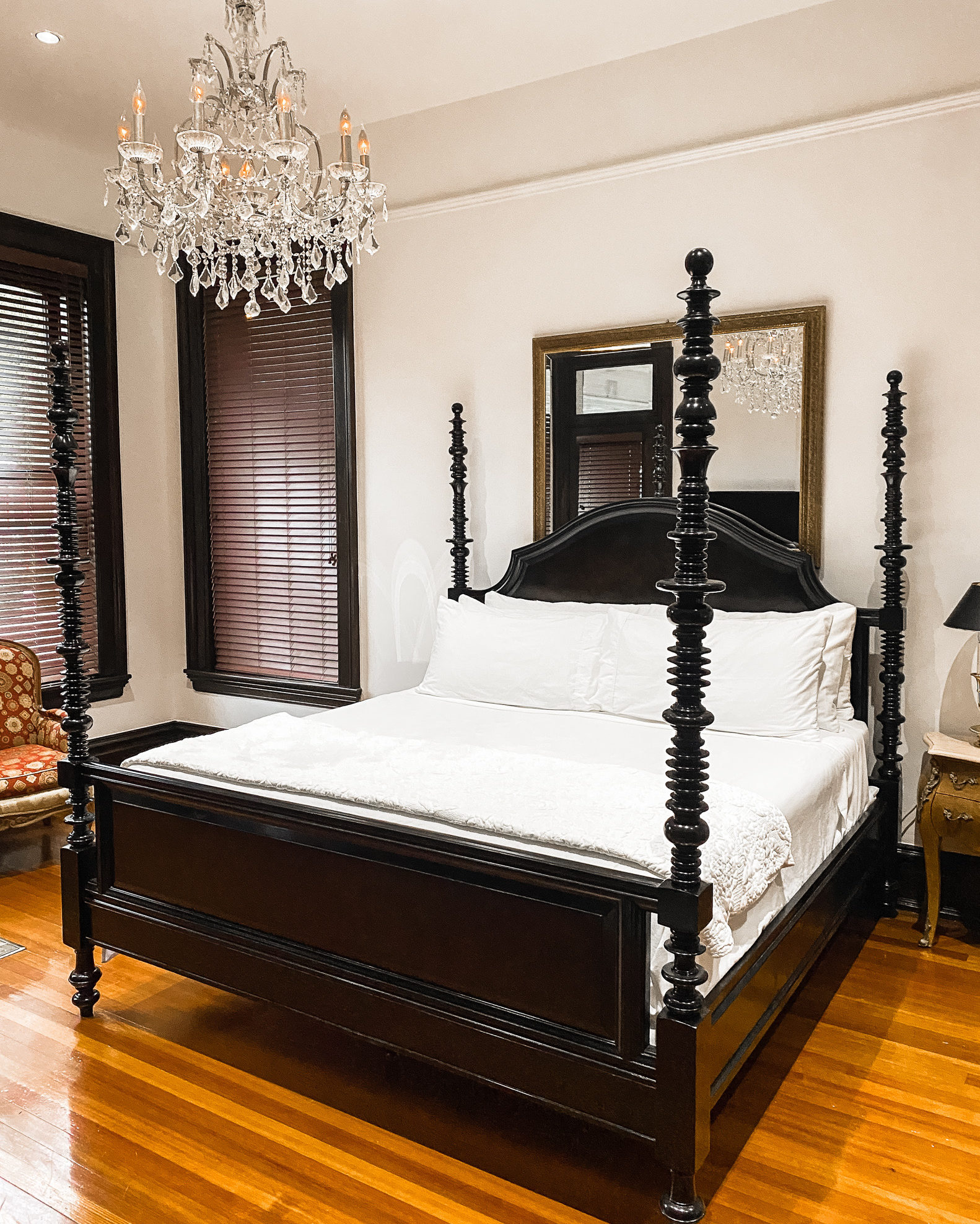 Big bed with white sheets and black dashboard