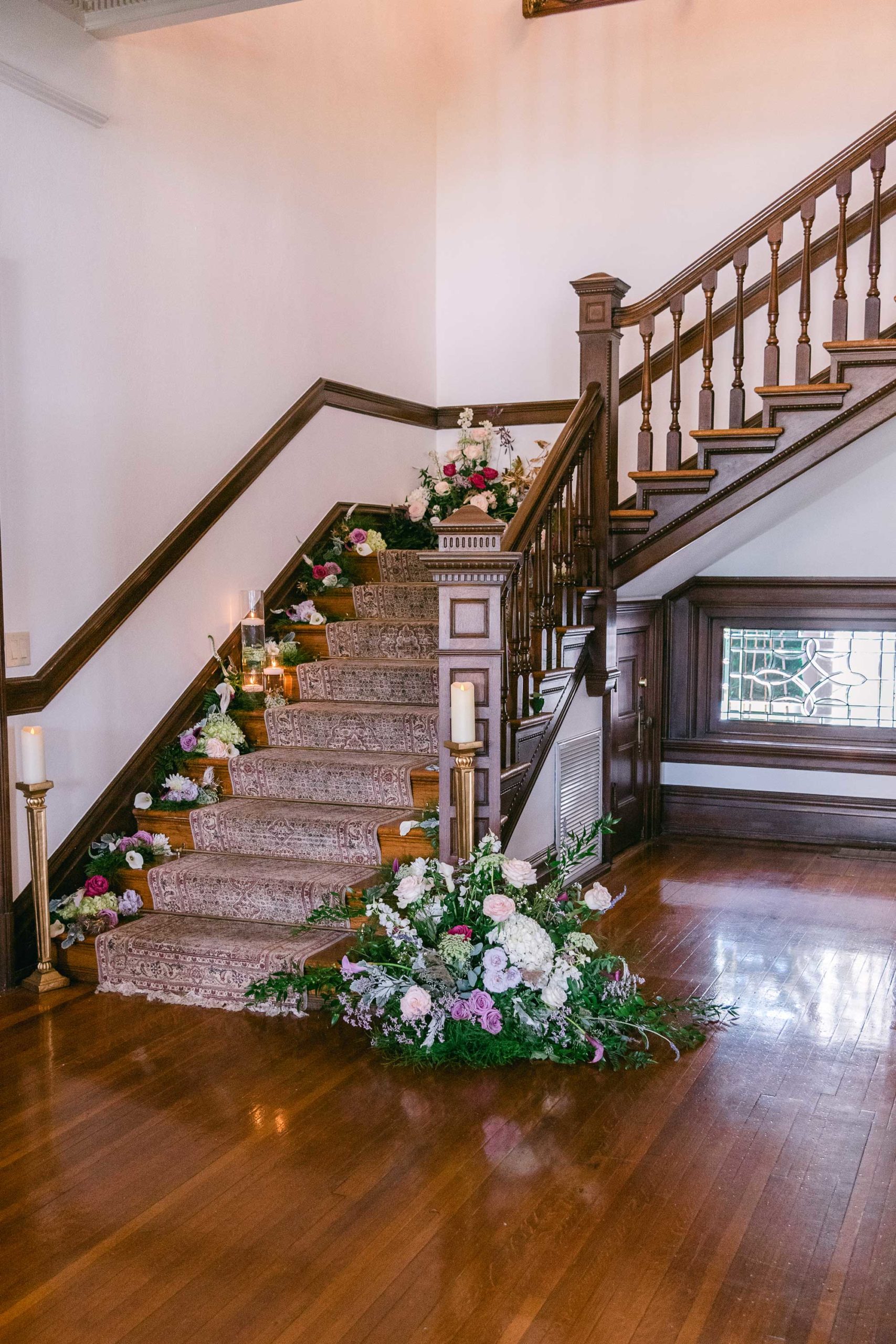 Decorated staircase with beige carpet